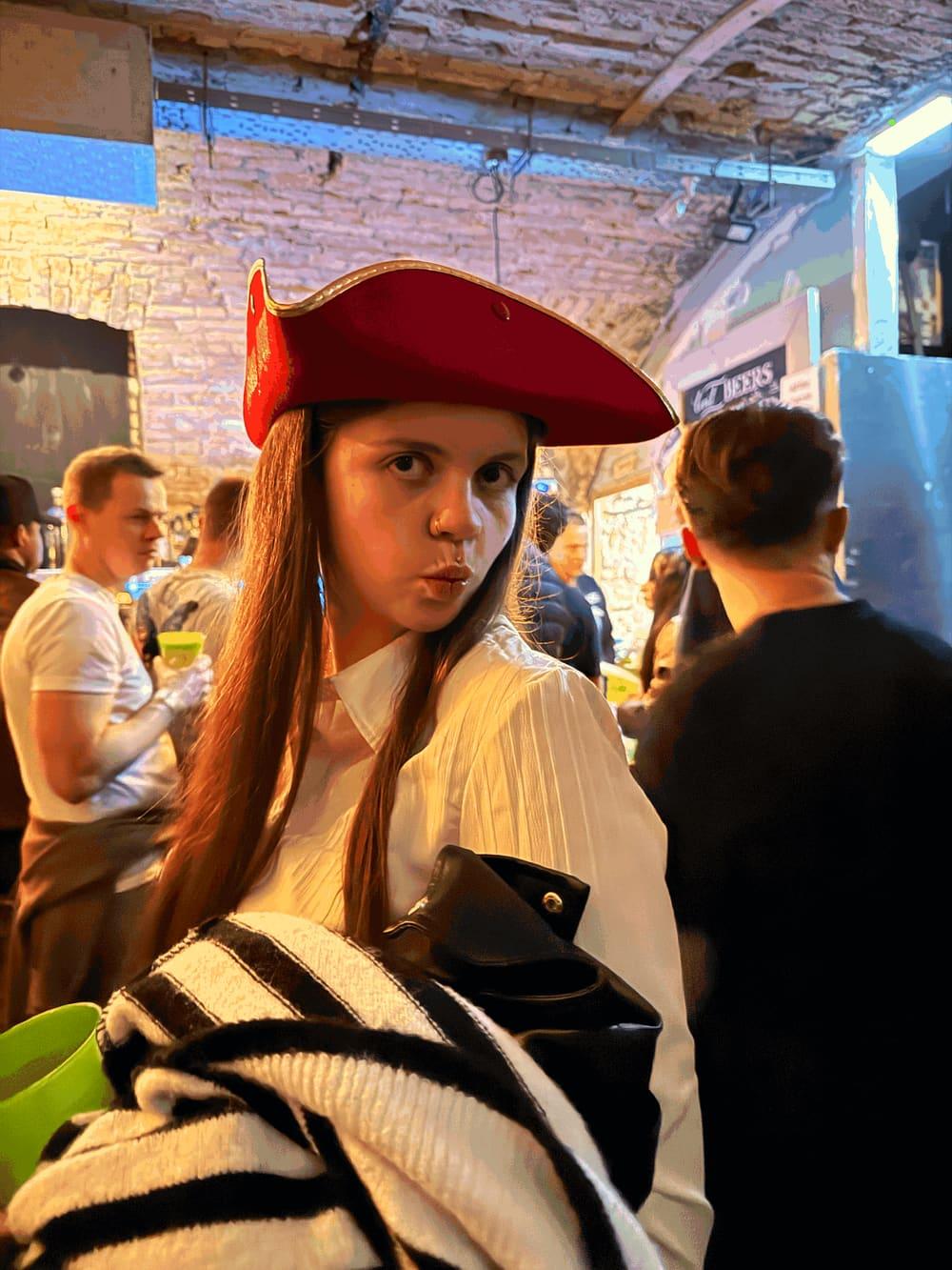 Guest in a red pirate hat at a busy Budapest ruin bar on the Budapest Ruin Crawl